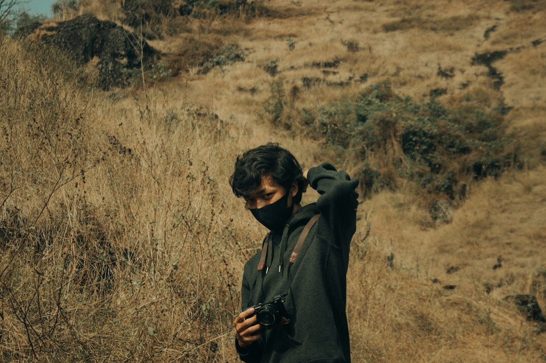man hiding items in jacket